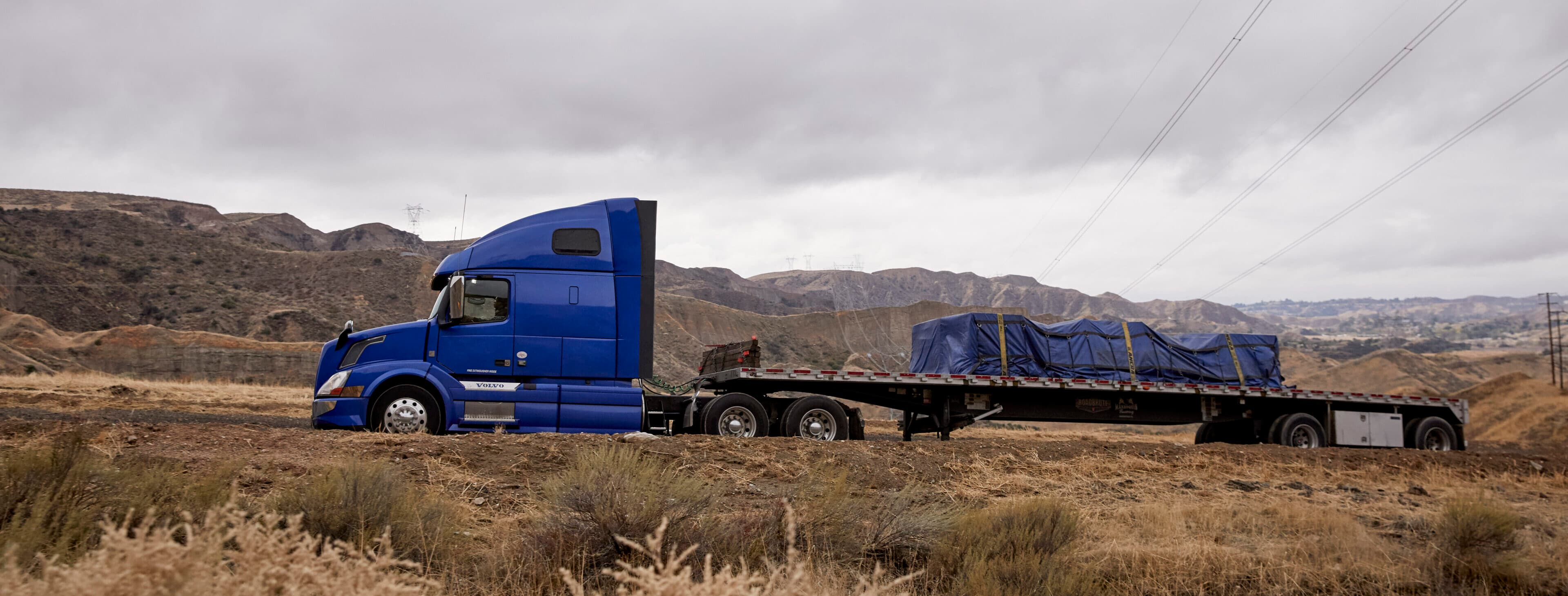 Professional flatbed transport truck carrying oversized cargo - Bolt Transline specialized equipment services